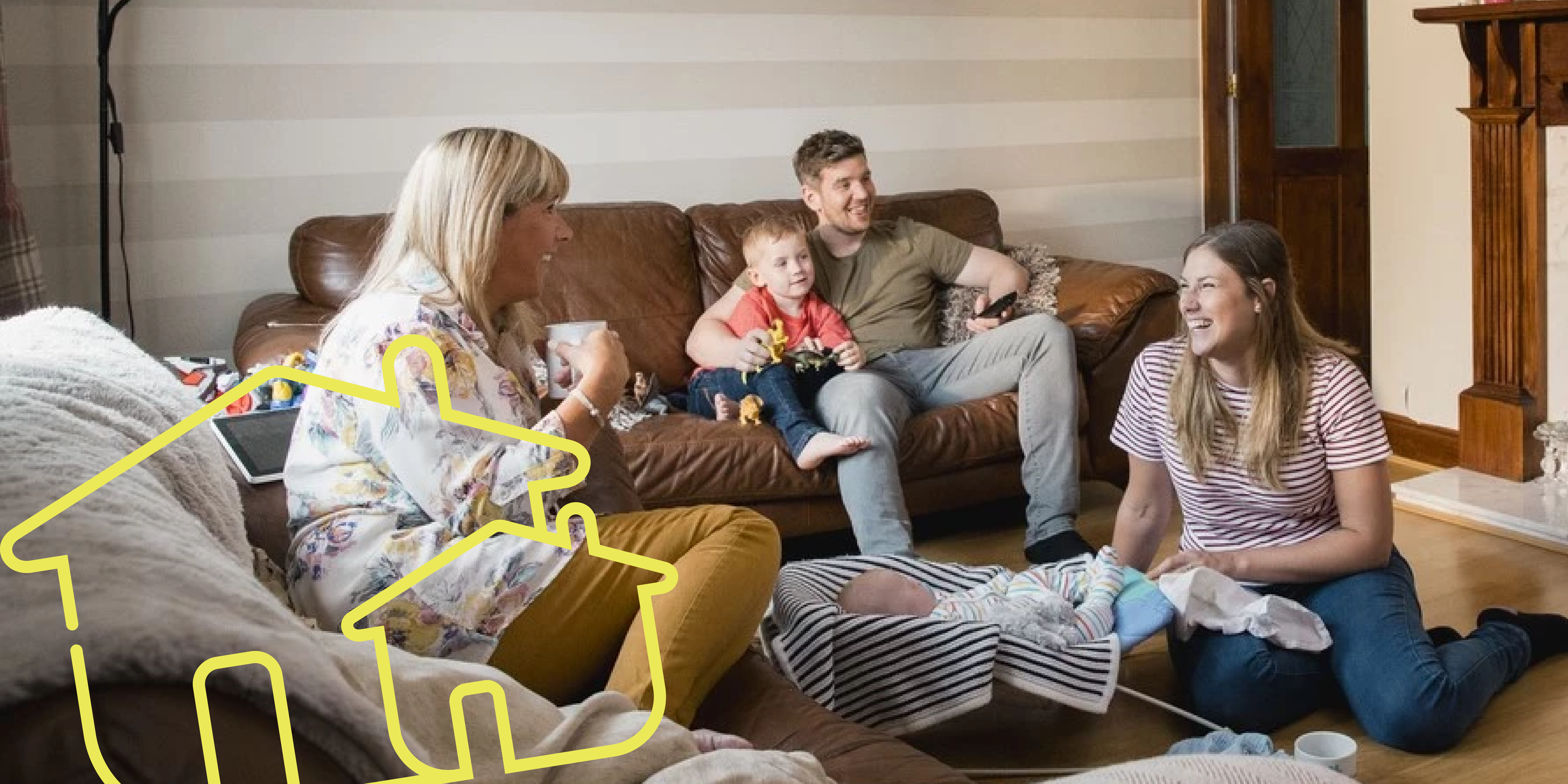 Young parent with two small children and grandmother chatting in front room