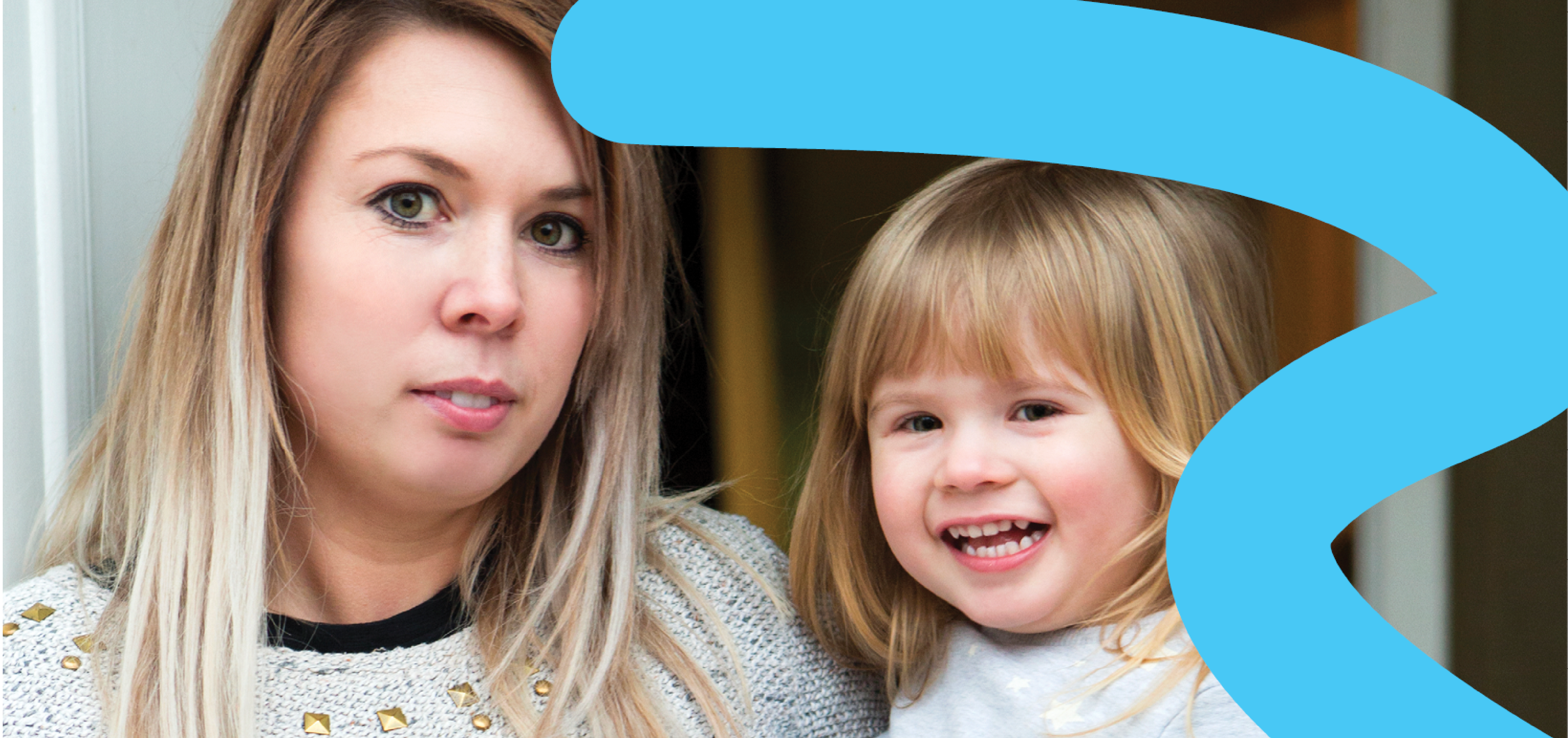 Young mother with infant daughter smiling at the camera